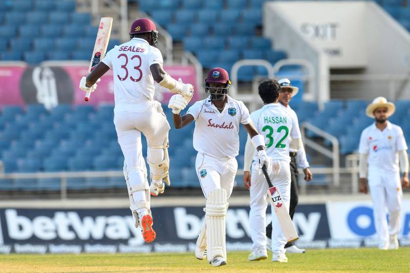 Jayden Seales (L) and Kemar Roach (2L) of West Indies celebrate winning on day 4 of the 1st Test between West Indies and Pakistan at Sabina Park, Kingston, Jamaica, on August 15, 2021.  (Photo by Randy Brooks  /  AFP)