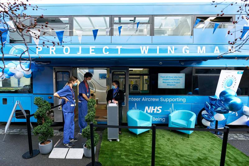 Anita Berg welcomes health workers to the Well-being bus at Homerton University hospital in London. The bus, which is staffed by volunteer aircrew, is providing free drinks and snacks to NHS staff. AP Photo