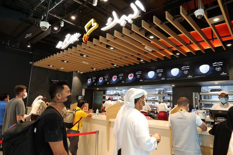 There are separate queues to place orders and pick up meals at Al Baik's Expo 2020 branch. Pawan Singh / The National