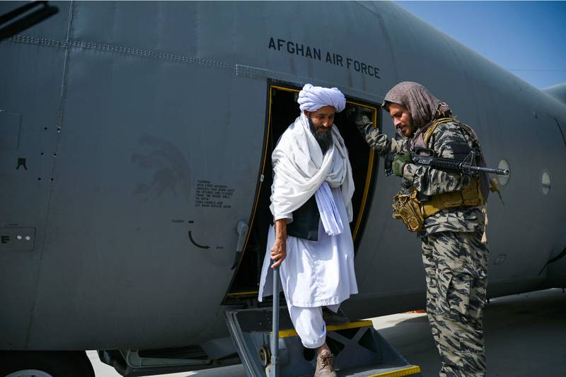 A member of the Taliban walks out of an Afghan Air Force aircraft. AFP