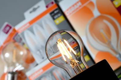 FILE PHOTO: A lit bulb by German lighting manufacturer Osram is seen in front of packages with different Osram bulbs in this picture illustration taken September 1, 2019. REUTERS/Andreas Gebert/File Photo