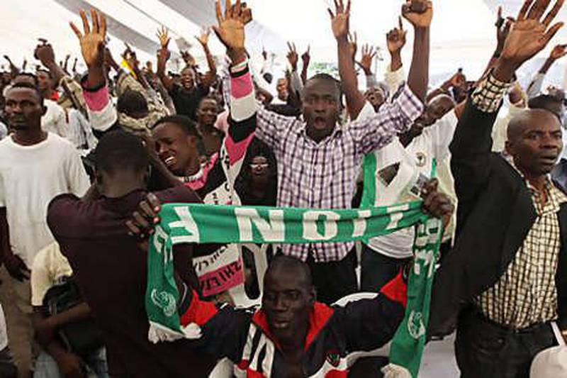 Nigerian fans celebrate after watching Kalu Uche score a goal against Greece, on a screen in a World Cup fan park in Lagos, Nigeria yesterday. The Nigerians also had plenty of support from fellow Africans in fan parks in South Africa as they went down 2-1 in their Group B clash.