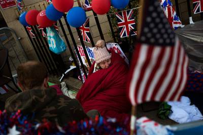 A woman spends the night near Windsor castle in order to reserve her vantage point for the wedding procession. Emilio Morenatti /AP Photo