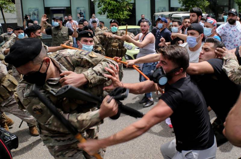 Supporters of Lebanon's top prosecutor Ghassan Oueidat clash with security forces during a protest against Judge Ghada Aoun, the chief prosecutor of the Mount Lebanon region, in Beirut, Lebanon. EPA
