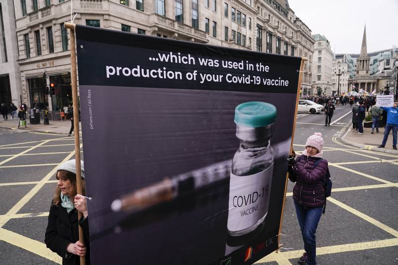 Anti-vaccine protesters with a placard in the UK's capital, London. AP