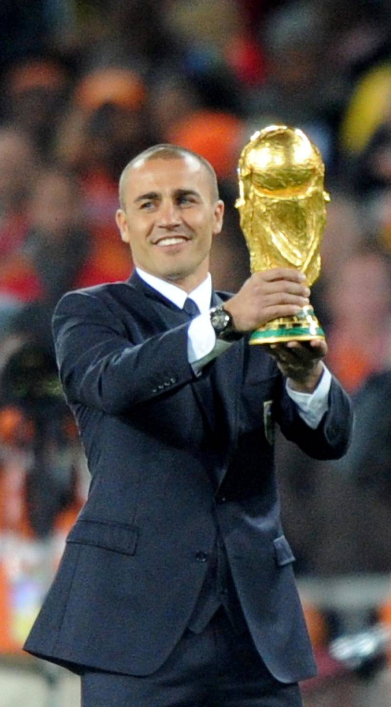 Italian footballer Fabio Cannavaro, captain of the 2006 World Cup winning team presents the world cup trophy prior to the 2010 FIFA football World Cup final between the Netherlands and Spain on July 11, 2010 at Soccer City stadium in Soweto, suburban Johannesburg. NO PUSH TO MOBILE / MOBILE USE SOLELY WITHIN EDITORIAL ARTICLE -  AFP PHOTO / PEDRO UGARTE / AFP PHOTO / PEDRO UGARTE