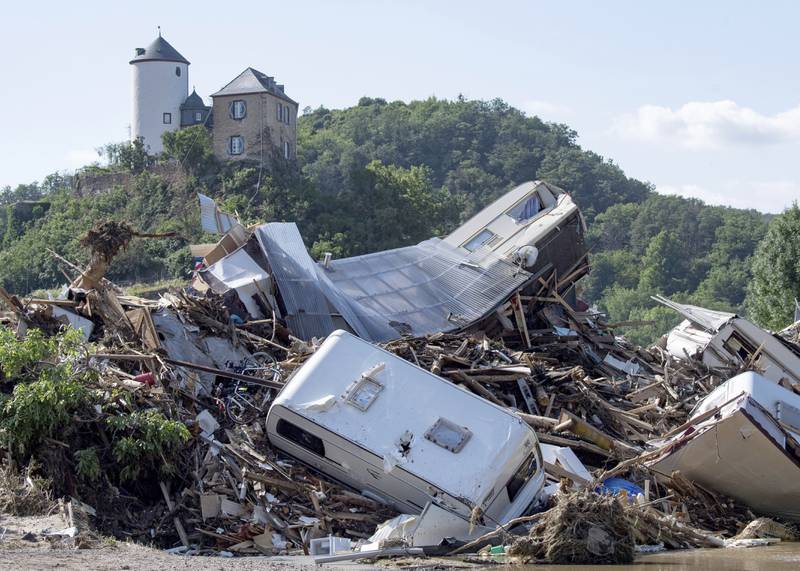 Dozens of caravans, cars and mobile homes that were swept away by the flood pile up together on a bridge over the River Ahr, in Altenahr, western Germany.