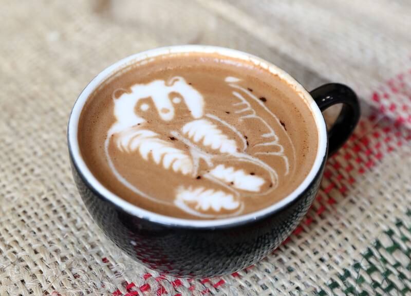 The finished piece, a panda, elevates this cup of coffee.