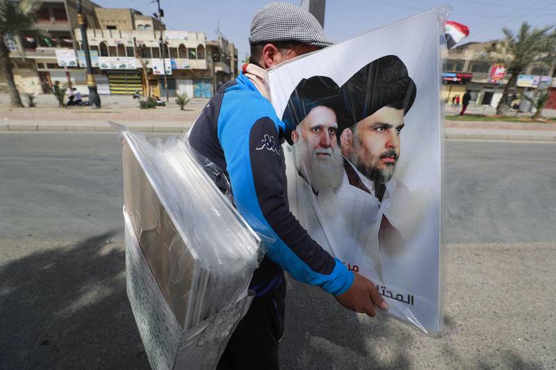 A street vendor offers a poster depicting Iraqi Shiite cleric Moqtada Al Sadr, right, and his father Mohammed Sadeq Al Sadr.  AFP