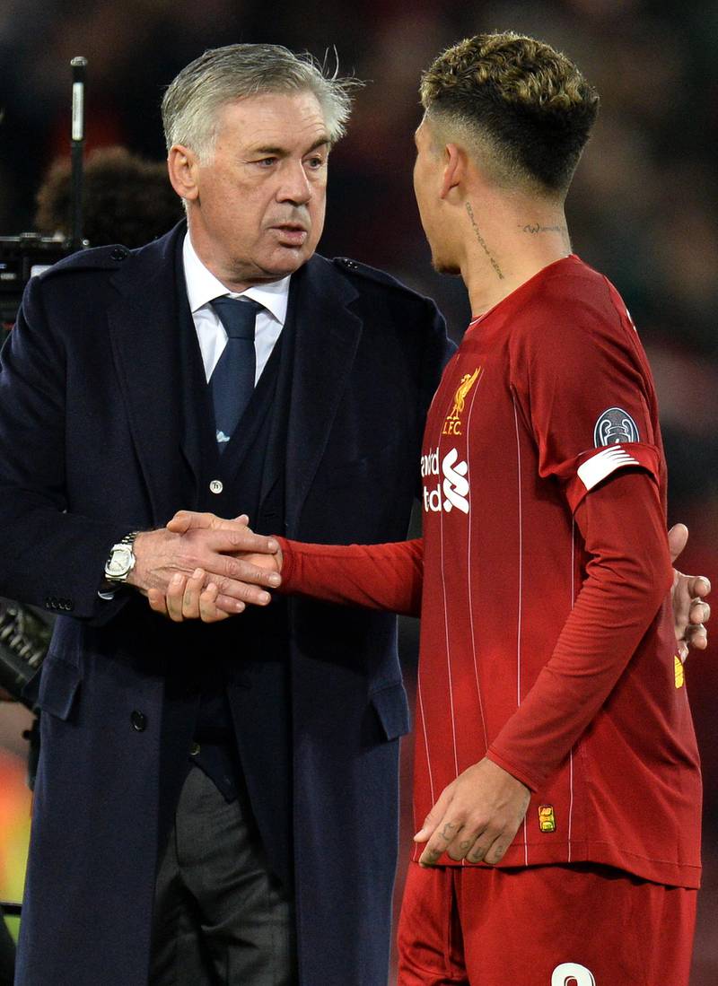 Napoli coach Carlo Ancelotti shakes hands with Liverpool forward Roberto Firmino. EPA