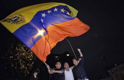 Venezuelan opposition supporters celebrate the results of the legislative election in Caracas, on  December 7, 2015 as Venezuela's opposition won a majority of 99 out of 167 seats in the state legislature – the first such shift in power in congress in 16 years. Luis Robayo/AFP Photo