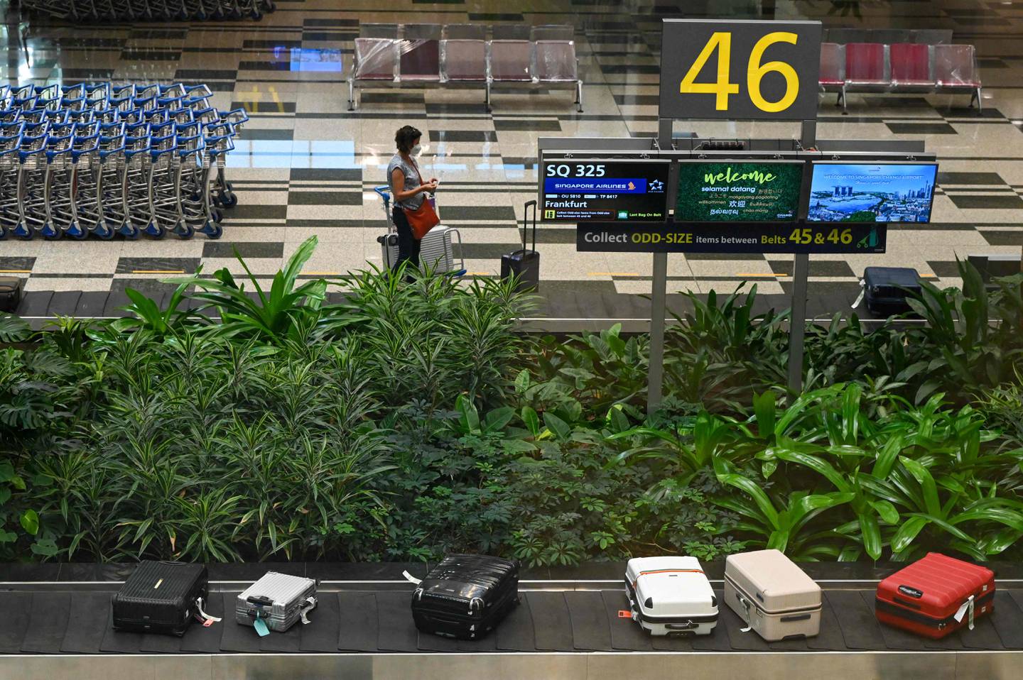 A passenger awaits his luggage at Changi Airport in Singapore. AFP