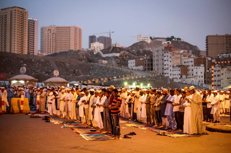 Muslim worshippers pray on the road outside the Grand Mosque in Mecca ahead of Hajj.  Mast Irham / EPA