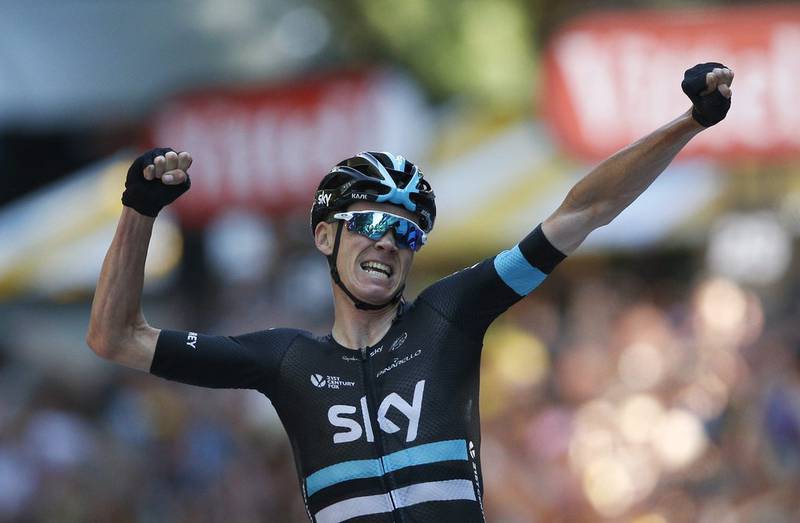 Britain’s Chris Froome celebrates as he crosses the finish line to win the eighth stage of the Tour de France on Saturday. Christophe Ena / AP Photo / July 9, 2016
