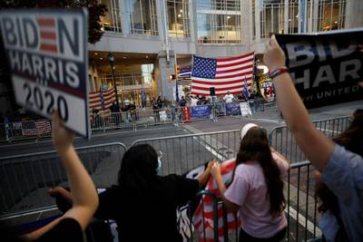Supporters of President-elect Joe Biden face off over barriers against supporters of President Donald Trump protesting outside the Pennsylvania Convention Center in Philadelphia, Sunday, Nov. 8, 2020, a day after the 2020 election was called for Democrat Biden. (AP Photo/Rebecca Blackwell)