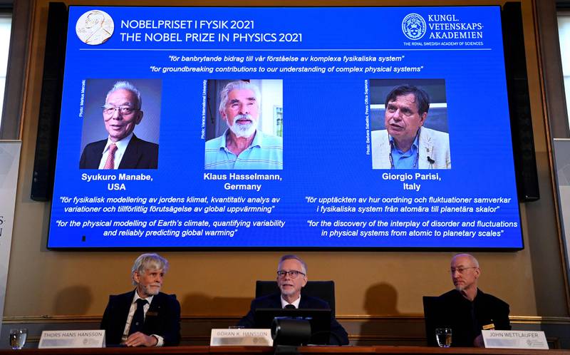 The winners of the 2021 Nobel Prize in Physics are displayed on a screen in Stockholm, Sweden. Photo: AFP