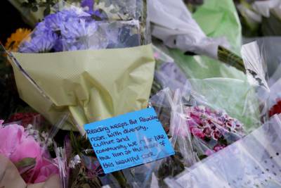 A message is shown on flowers near the scene of a fatal multiple stabbing attack in Forbury Gardens, central Reading, England, Monday June 22, 2020.  AP Photo