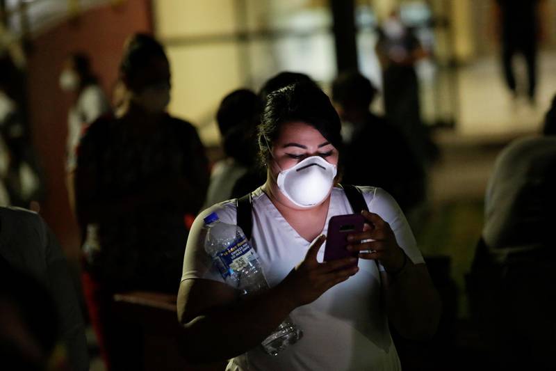 A nurse from General Hospital No. 6 of the Mexican Institute of Social Security checks her phone during a protest after the death of a colleague, due to what they say is the lack of equipment to treat patients with the coronavirus disease, in Ciudad Juarez, Mexico. Reuters