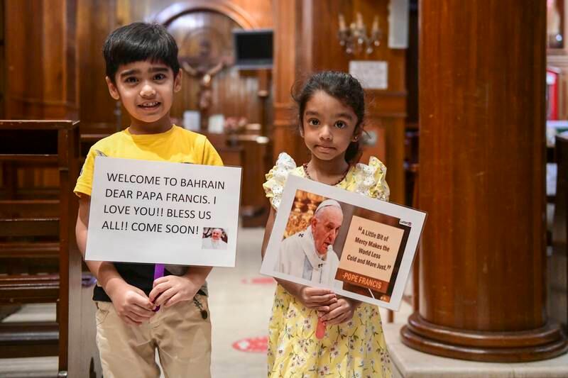 Jeff Fernandes and Evanka Sequeira with the signs they made to welcome Pope Francis.
