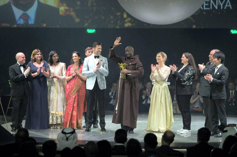 DUBAI, UNITED ARAB EMIRATES - Winner of the Global Teacher Prize 2019 Peter Tabichi from Kenya with actor Hugh Jackman and the teacher finalist at the Global Education and Skills Forum 2019 at Atlantis, The Palm.  Leslie Pableo for The National for Anam Rizvi's shorty
