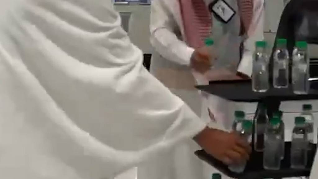 Robots serve Zamzam water bottles at the Grand Mosque in Makkah