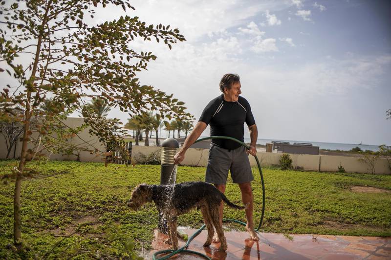 Carlos Duarte, professor of Marine Science and Tarek Ahmed Juffali Research Chair in Red Sea Ecology at  KAUST, washes his dog at his home at the campus. Reuters