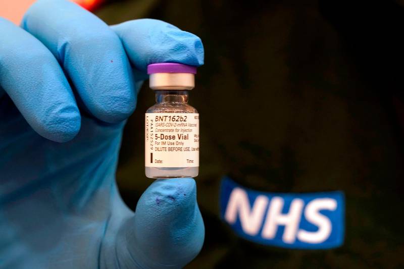 A vial of the Pfizer-BioNTech COVID-19 vaccine is held as preparations are made at a mass vaccination hub, the Centre For Life in Newcastle-upon-Tyne, in north-east England on January 9, 2021, ahead of it's opening on Monday. The Centre For Life in Newcastle vaccinated key workers this weekend. It will be one of seven mass vaccination hubs opening around the country. UK health officials and ministers have described the vaccination roll-out as a head-to-head race against the virus and the vaccination programme as the best hope of a return to normality. / AFP / POOL / Owen Humphreys

