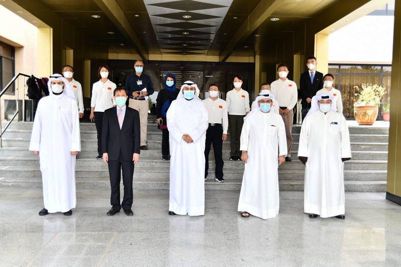 Hand out photo released by KUNA on April 28, 2020, shows Kuwait's Health Minister Sheikh Basil al-Sabah (C), as he receives members of a Chinese health delegation visiting Kuwait to exchange experiences on strategies, plans, and procedures to contain COVID-19 coronavirus disease. AFP