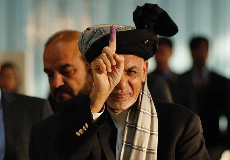 Afghan president Ashraf Ghani shows his inked finger after casting his vote in the opening event of Afghanistan parliamentary election in Kabul, Afghanistan. EPA