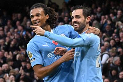 Bernardo Silva celebrates with Nathan Ake after scoring Manchester City's second goal in their 6-1 Premier League win over Bournemouth at the Etihad Stadium on November 4, 2023. AFP