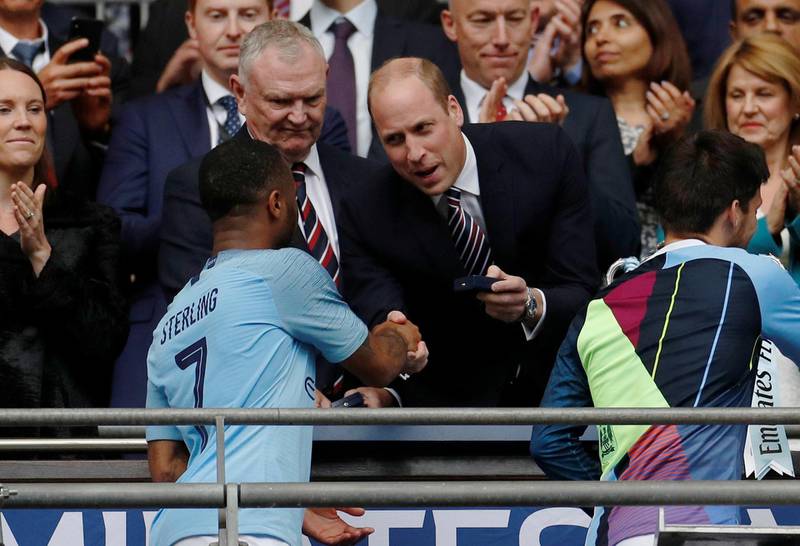 Manchester City's Raheem Sterling shakes hands with with Britain's Prince William as they celebrate winning the FA Cup. Reuters