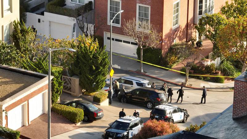 San Francisco police officers and FBI  agents gather in front of the Pelosi home after the attack. Getty Images / AFP