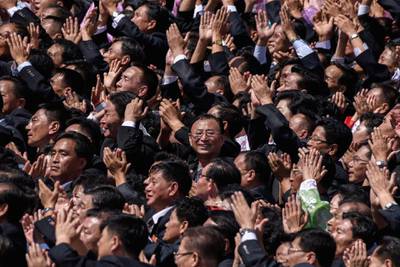 Participants cheer as they look towards a balcony from where North Korea's leader Kim Jong Un was watching, during a military parade and mass rally on Kim Il Sung square in Pyongyan.  AFP