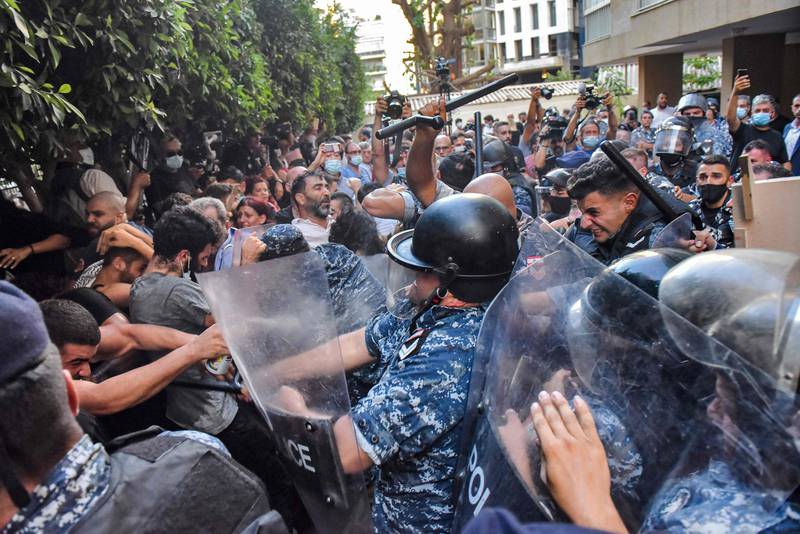 Protesters scuffle with security forces as they attempt to break into the residence of Lebanon's interior minister in the Qoraitem neighbourhood of western Beirut.