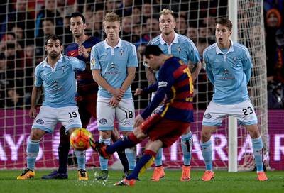 Barcelona's Argentinian forward Lionel Messi shoots a free kick to score a goal during the Spanish league football match FC Barcelona vs RC Celta de Vigo at the Camp Nou stadium in Barcelona on February 14, 2016. (Photo by JOSEP LAGO / AFP)