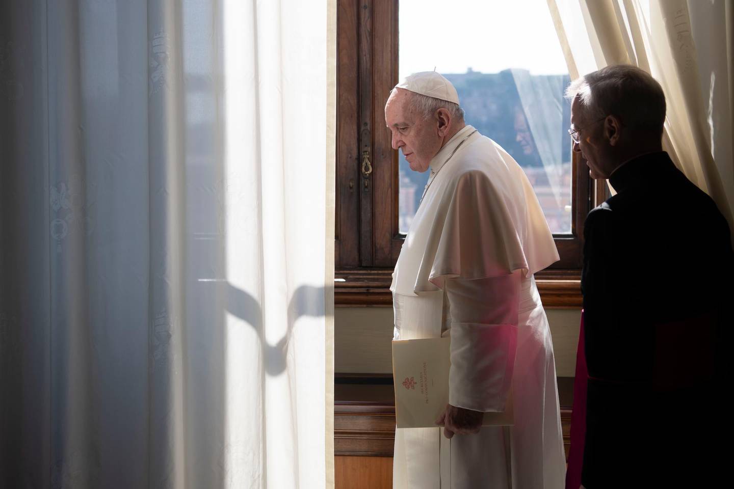 Pope Francis leaves after his weekly general audience at the Vatican, Wednesday, March 18, 2020. For most people, the new coronavirus causes only mild or moderate symptoms. For some it can cause more severe illness, especially in older adults and people with existing health problems. (Vatican News via AP)