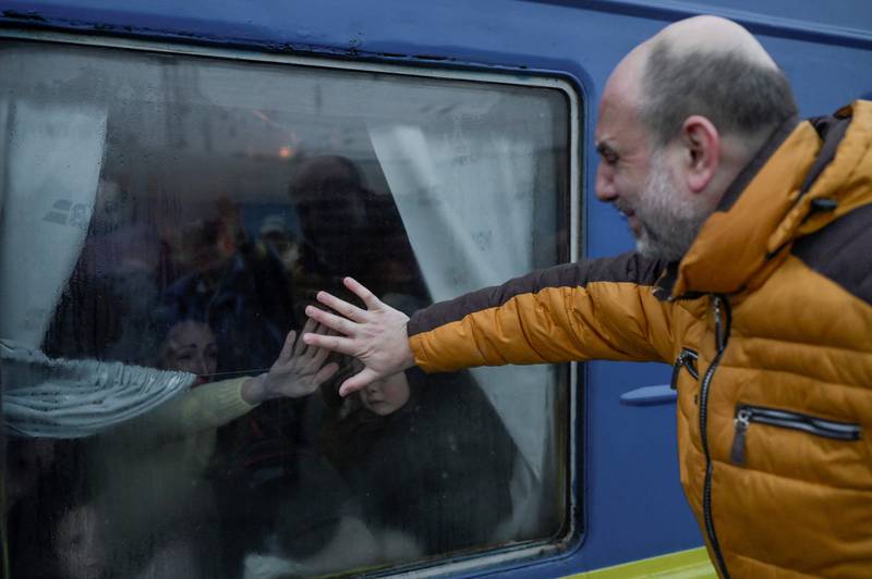 A father cries as he bids farewell to his family at the central train station in Odessa, amid the war in Ukraine. AFP