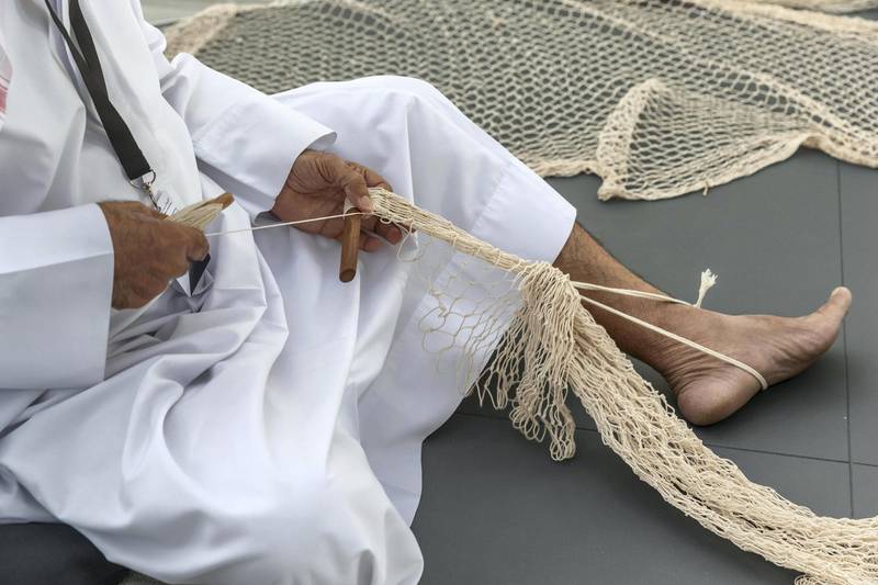 ABU DHABI, UNITED ARAB EMIRATES. 01 DECEMBER 2018. BIGPICTURE OPTION. UAE National Day Program at the Louvre Abu Dhabi. An Emirati man weaves fish nets in a traditional manner. (Photo: Antonie Robertson/The National) Journalist: None. Section: National.