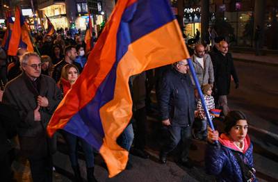 epa09057201 Supporters of the National Democratic Pole of Armenia movement carry Armenian flag during a protest against Prime Minister Nikol Pashinyan in Yerevan, Armenia, 06 March 2021. Nikol Pashinyan said that early parliamentary elections could be held in 2021. Pashinyan faced protests with calls to resign after the handling of a six-week conflict between Azerbaijan and Armenian forces over the region of Nagorno-Karabakh in 2020.  EPA/NAREK ALEKSANYAN