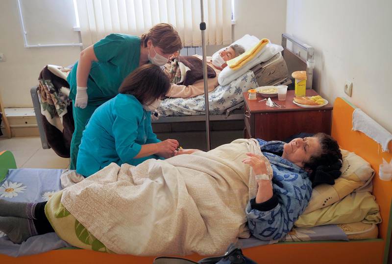 Nurses administer medicine to a patient wounded from shelling by Azerbaijan's artillery in a hospital, during a military conflict in Stepanakert, the separatist region of Nagorno-Karabakh, Saturday, Oct. 17, 2020. The latest outburst of fighting between Azerbaijani and Armenian forces began Sept. 27 and marked the biggest escalation of the decades-old conflict over Nagorno-Karabakh. The region lies in Azerbaijan but has been under control of ethnic Armenian forces backed by Armenia since the end of a separatist war in 1994. (AP Photo)