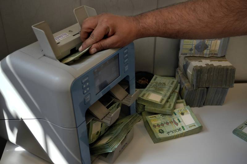 A worker at a money exchange bureau counts Lebanese pounds in Beirut, Lebanon, Thursday, Sept.  22, 2022.  (AP Photo / Bilal Hussein)