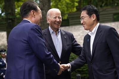 US President Joe Biden, centre, with South Korean President Yoon Suk-Yeol, left, and Japanese Prime Minister Fumio Kishida at Camp David. EPA