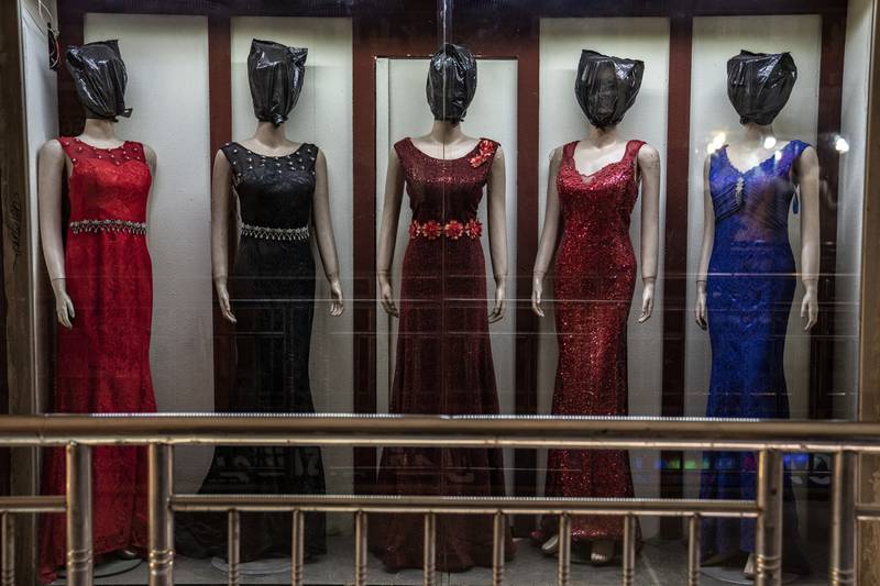Mannequins in evening gowns and dresses — and all in various types of head coverings