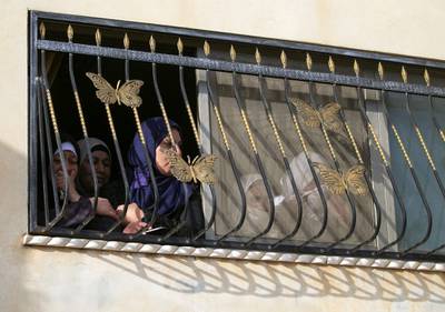 Women watch the funeral of Mohammed Hamayel from a home in the West Bank village of Beita. AFP
