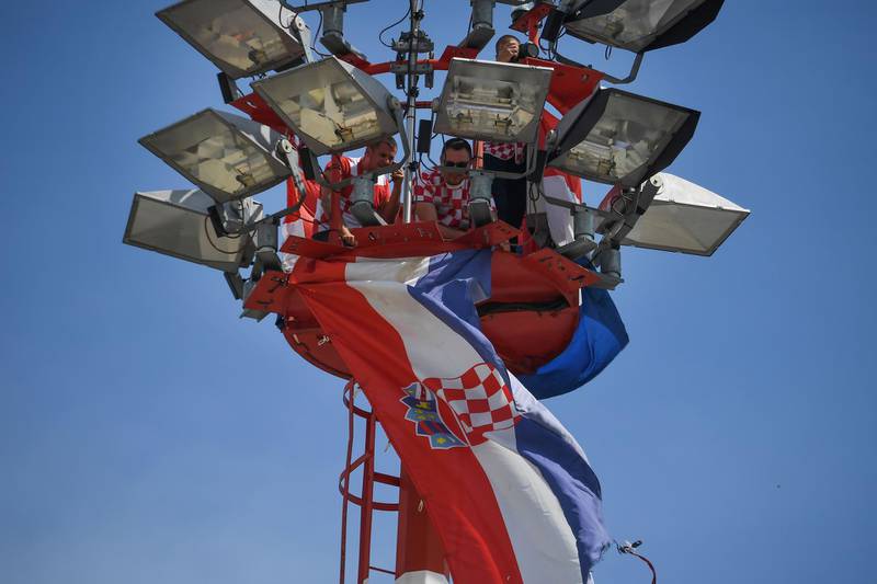 Croatian workers prepare a giant flag on the top of an airport tower at the Zagreb international airport. Attila Kisbenedek / AFP