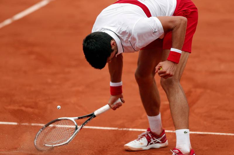 Novak Djokovic smashes his racquet as he plays Roberto Bautista Agut of Spain during their men's third round match during the French Open in 2018. EPA