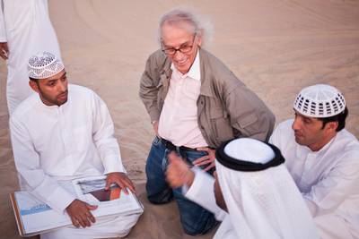 MADINAT ZAYED, UNITED ARAB EMIRATES,  October 10, 2012. Christo Yavacheff (center), a Bulgarian born instalation artistsnow living in New York, meets with Liwa residents Khalfan Al Qubasi (L) Saeed Al Falahi (R) and Obaid Al Mazrouei (front R) to discuss his plans to construct in Liwa a pyramid of 415,000 oil drums that will be bigger than the main pyramid of giza. (ANTONIE ROBERTSON / The National)