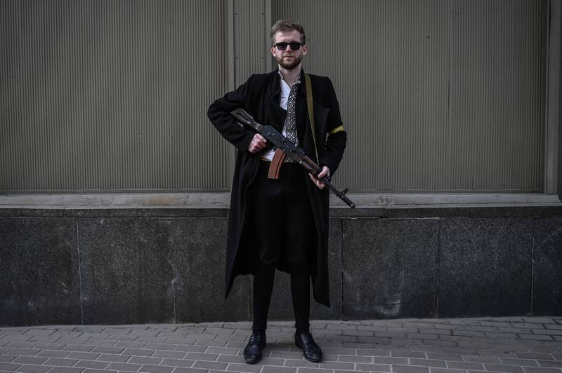 Sviatoslav Yurash, 26, a politician from President Volodymyr Zelenskyy’s Servant of the People party, poses with his assault rifle as he patrols Kiev. AFP