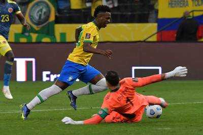 Brazil's Vinicius Junior and Colombia's goalkeeper David Ospina vie for the ball. AFP