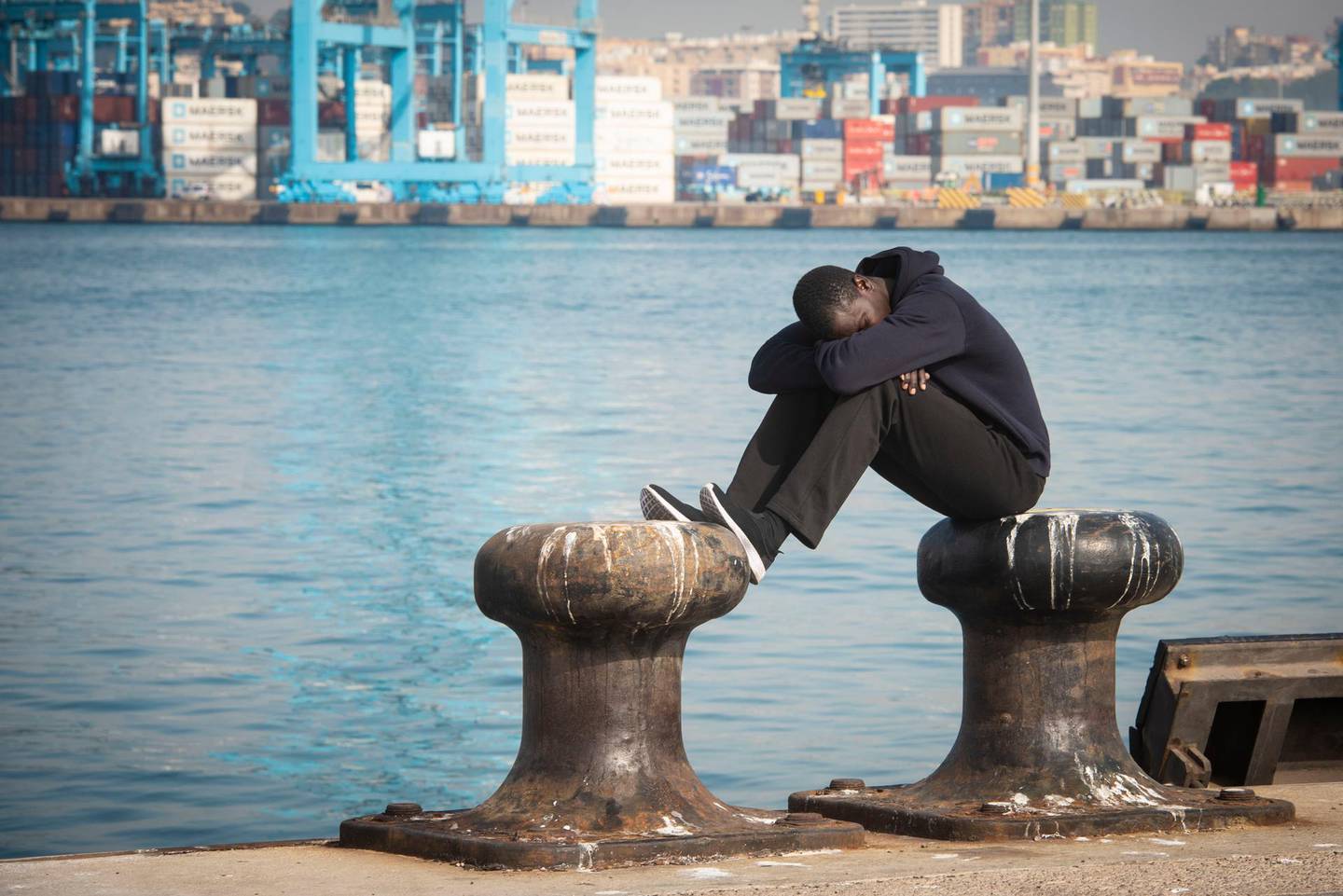 A migrant rests at the dock of the port of Algeciras, southern Spain, after being rescued by Spain's Maritime Rescue Service in the Strait of Gibraltar on Wednesday, Aug. 1, 2018. Spain's foreign minister says the European Union's executive branch has allocated 55 million euros ($64.2 million) to manage an upsurge of migrant arrivals mostly from Morocco. With nearly 23,000 arrivals recorded so far, Spain has become this year the main entry point into Europe for migrants crossing the Mediterranean Sea by boat. (AP Photo/Marcos Moreno)